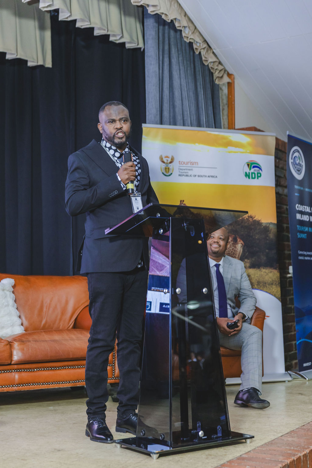 Speaker at the Investment Summit lectern